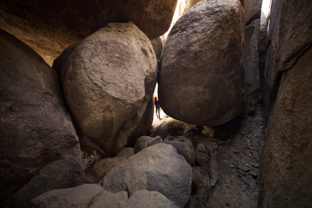 A narrow passage between giant boulders