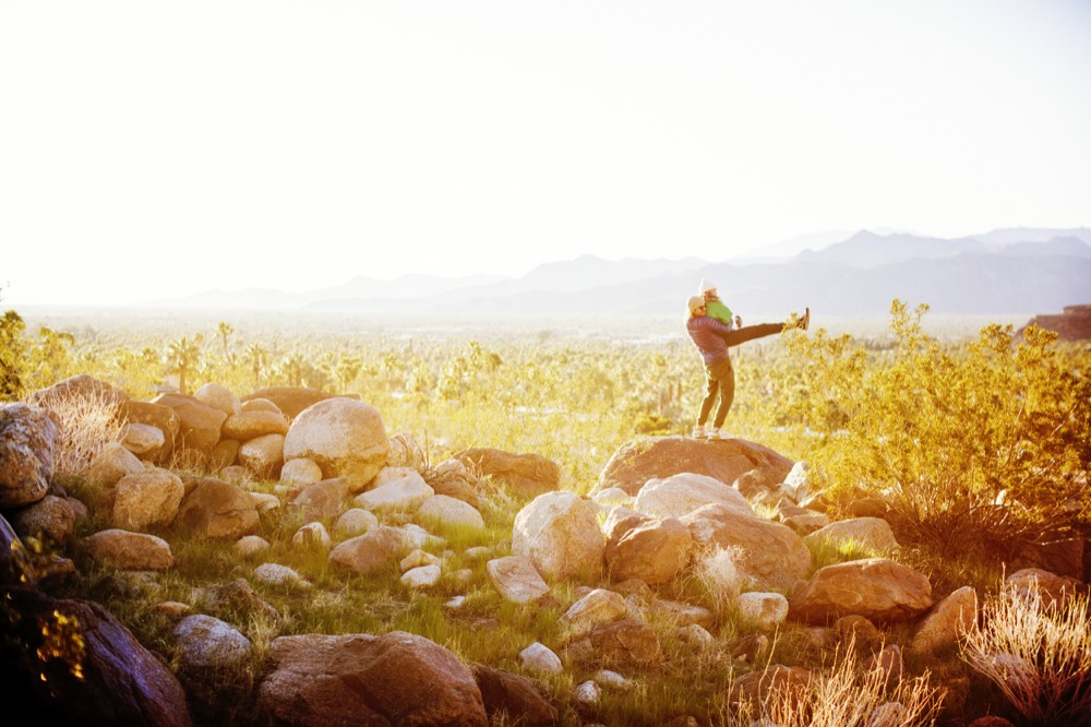 A figure stretching on the rocks in a glowing golden field