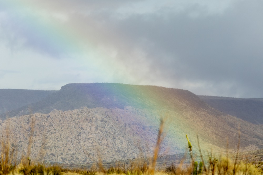 A rainbow over a flat-topped mesa